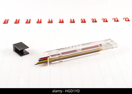 Colorful pencil leads on white notebook Stock Photo