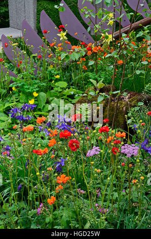 Colourful mixed planted flower border, meadow including Dahlias, Clematis and Ferns Stock Photo