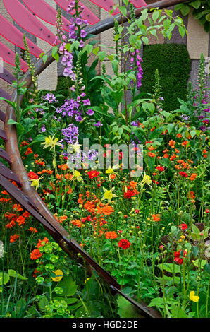 Colourful mixed planted flower border, meadow including Dahlias, Foxgloves, Poppies, Aquilegia, Clematis and Ferns Stock Photo