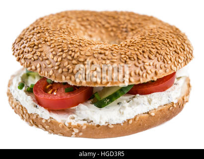Fresh made cream cheese Bagel (selective focus; close-up shot) isolated on white background Stock Photo