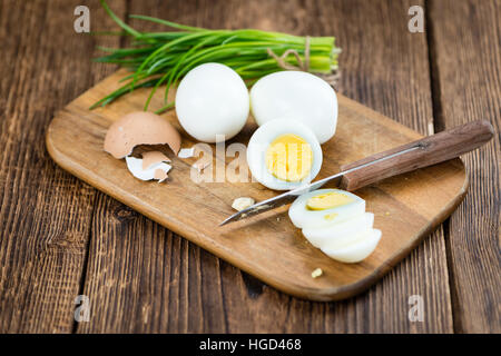 Portion of boiled Eggs (sliced) on vintage looking background (selective focus) Stock Photo