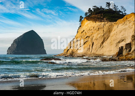 Atmospheric landscape, ocean waves wash the Cape Kiwanda beach on the Oregon coast area of Pacific City. Stock Photo