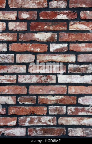 A brick wall newly fitted with concrete seam. Stock Photo