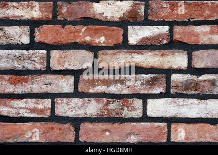 A brick wall newly fitted with concrete seam. Stock Photo