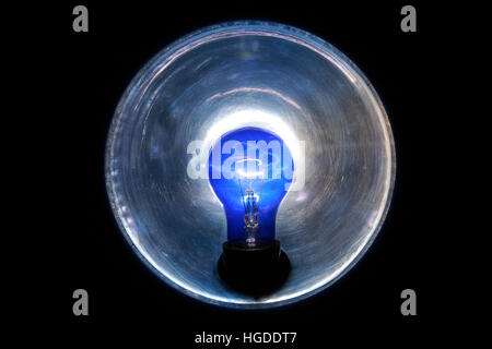 Burning blue lamp with a reflector on a black background Stock Photo