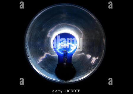Burning blue lamp with a reflector on a black background Stock Photo