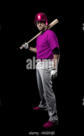 Baseball Player with a pink uniform on a black background. Stock Photo