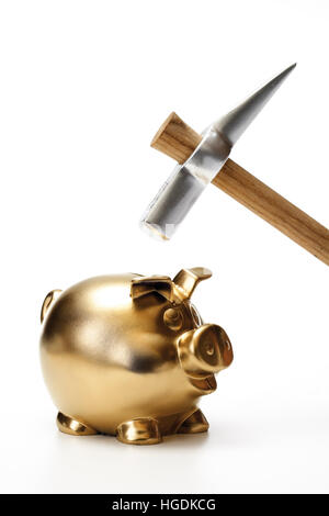 Gold piggy bank with a hammer Stock Photo - Alamy