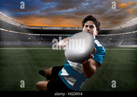 Rugby player in a blue uniform on a stadium. Stock Photo