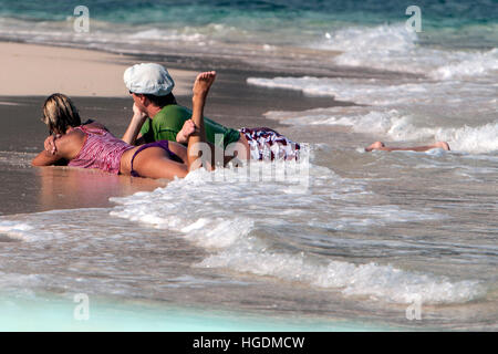 Couple relax on remote beach Bacuit Archipelago Palawan Philippines Stock Photo