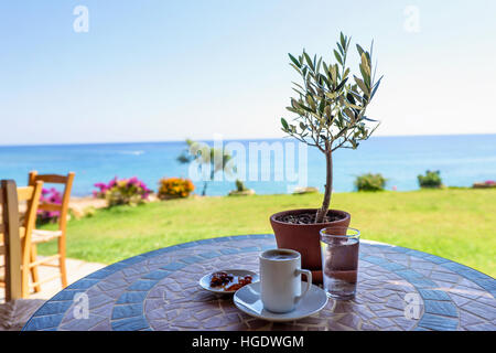 beach glass cup with blue top and blue straw on white table with gray white  background Stock Photo - Alamy