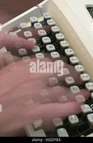 blurred hand typing on typewriter Stock Photo