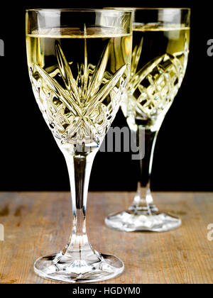 Chilled White Wine in a Cut Crystal Glass Against a Black Background Stock Photo