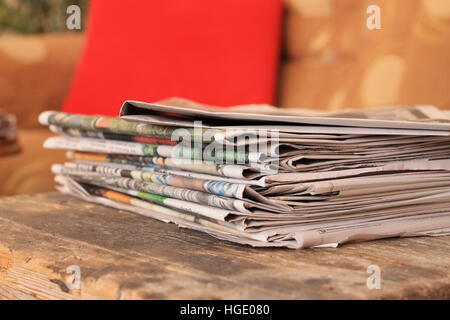 Newspapers on wooden table Stock Photo