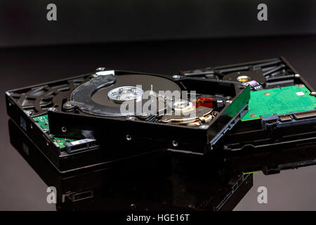 3 hard drives on a black surface and background Stock Photo