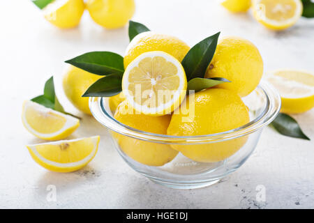 Fresh lemons in a glass bowl Stock Photo