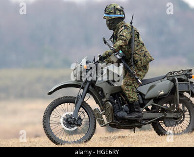 Narashino, Japan. 8th Jan, 2017. A member of Japanese Ground Self Defense Forces' airbourne troops drives a motorcycle during the new year exercise at Defense Force's Narashino training ground in Chiba prefecture, suburban Tokyo on Sunday, January 8, 2017. © Yoshio Tsunoda/AFLO/Alamy Live News Stock Photo
