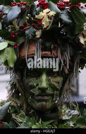 London, UK. 8th Jan, 2017. The Bankside Mummers celebrate Twelfth Night on the south bank. The Epiphany is the traditional end to the christmas season and winter greenery was brought indoors to 'keep the green' and encourage a sense of the return of warmer months. Holly man was played by David Risley;, Beelzabub played by Michael Palmer and St George played by Connor Nolan. © SANDRA ROWSE/Alamy Live News Stock Photo