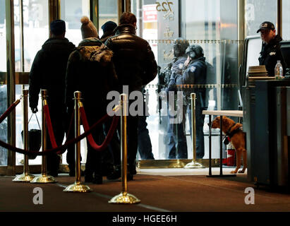 New York, New York, USA. 8th Jan, 2017. A New York City Police dog (R) watches people leave the lobby as he stands guard inside Trump Tower in New York, New York, USA, 8 January 2017. Photo: Jason Szenes/Consolidated/dpa/Alamy Live News Stock Photo