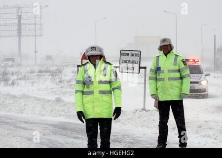 BUCHAREST, ROMANIA - January 06, 2017: A police car blocks the access on A2 motorway to the main harbor of Black Sea, Constanta, due to the snow storm Stock Photo