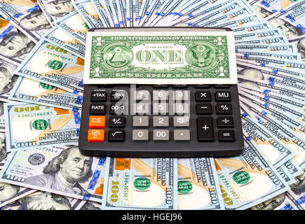 One american dollar and calculator on dollars background. Business concept Stock Photo