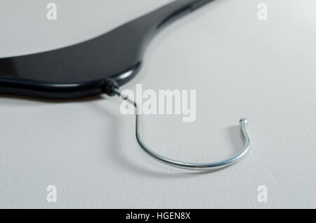 A Studio Photograph of the Hook of a Black Plastic Coat Hanger Stock Photo