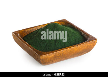 Spirulina powder in wooden bowl isolated on white background. Superfood Stock Photo