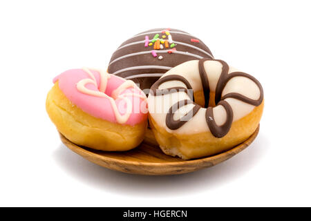 Tasty doughnuts in wooden plate on white background Stock Photo