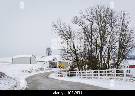 Road and view of snow covered farm, near Jefferson, Pennsylvania. Stock Photo