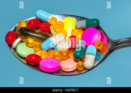 Many colorful pills tablets on a spoon Stock Photo