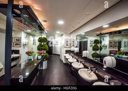 Wash basins in the gent's toilet at Royal Ascot Racecourse, Berks, UK. Rest room bathroom facilities Stock Photo