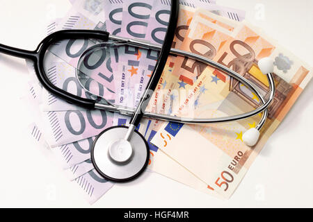 Stethoscope placed on Euro bills: symbolic for doctors' fees Stock Photo