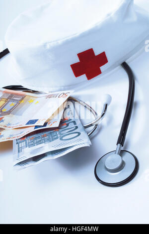 Stethoscope, nurses' cap and Euro bills: symbolic for hospital fees Stock Photo