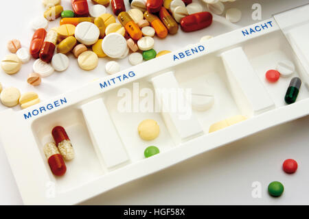 Tablets in compartmentalized pill dispenser, to be taken four times daily Stock Photo