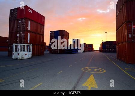 Containers stacked at terminal, evening, port, Antwerp, Belgium Stock Photo