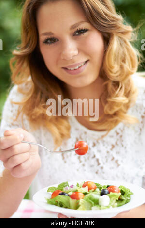 Teenage Girl Eating Healthy Bowl Of Salad Stock Photo
