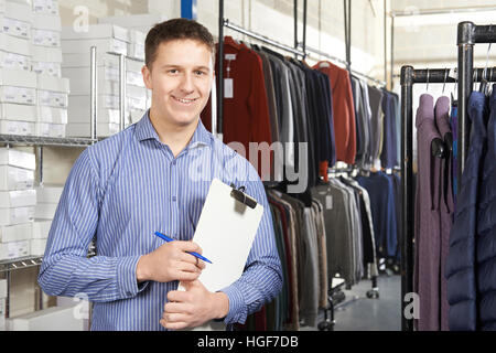 Businessman Running On Line Fashion Business With Clipboard Stock Photo