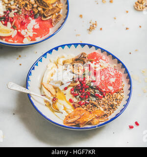 Healthy breakfast yogurt bowls with seeds, fruit, nuts, granola Stock Photo