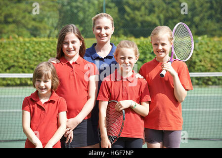 Portrait Of School Tennis Team With Teacher Stock Photo