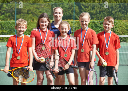 Victorious School Tennis Team With Medals Stock Photo