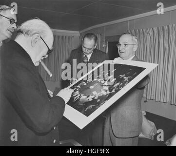 President Truman presenting British Prime Minister Winston Churchill with a photograph taken at the Potsdam Conference 1945 Stock Photo