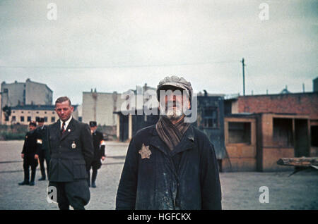 Ghetto Lodz, Litzmannstadt, Hans Biebow, chief of German Nazi administration of the ghetto and Jewish policemen watch an old jew, Poland 1940, World War II, Stock Photo