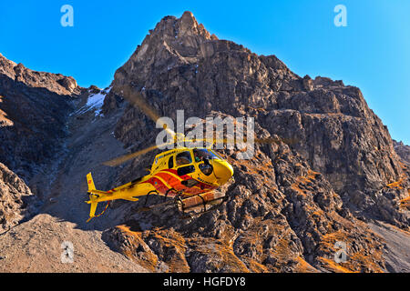 Helicopter Eurocopter AS350 Ecureuil of Heli Bernina AG operating in the Val Lischana, Engadin Alps, Graubunden, Grisons, Switzerland Stock Photo