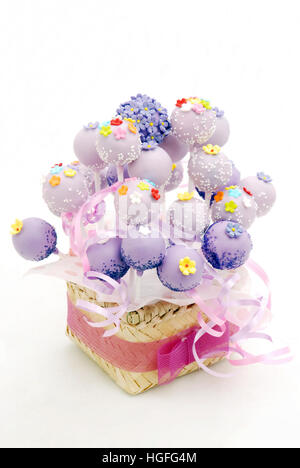 Cake pop bucket, a bunch of cake pops  decorate with webbing from bambo, with a ribbon Stock Photo