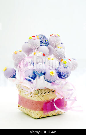 Cake pop bucket, a bunch of cake pops  decorate with webbing from bambo, with a ribbon Stock Photo