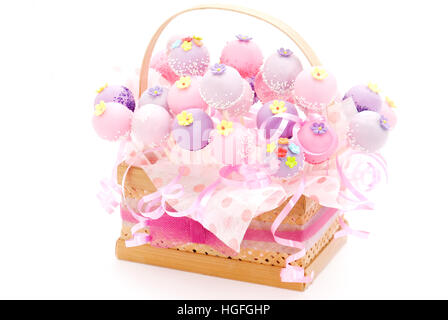 Cake pop bucket, a bunch of cake pops  in color purple and pink, decorate with webbing from bambo, with a ribbon Stock Photo