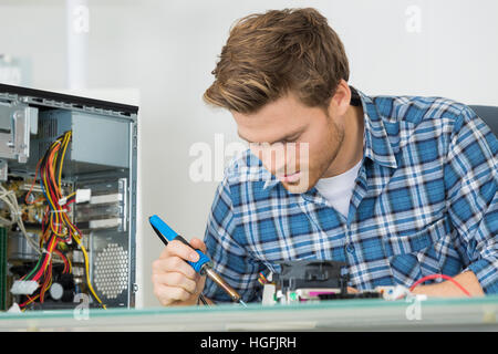 young man fixing computer Stock Photo