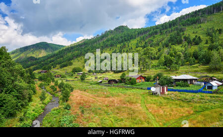 Old wooden houses with gardens in valley of a small stream. Village Maritui. Pribaikalsky National Park. Irkutsk region. Russia Stock Photo