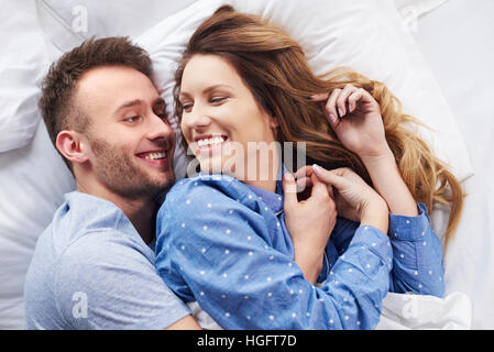 Morning laughs in bed with partner Stock Photo