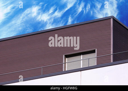 Abstract looking modern building detail against blue cloudy sky Stock Photo